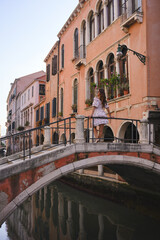 Woman standing on bridge in Venice Italy