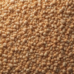 Fototapeta premium Seamless natural texture shows light brown granules. Small beige pellets mix with textured cork pieces. Organic eco material forms warm earthy background. Good for floor, wall, design, craft, decor,