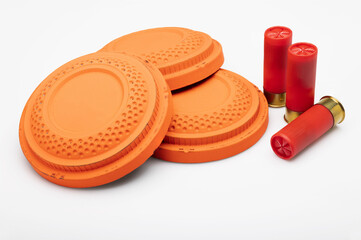 Red shotgun shell and clay pigeon target on white background , Gun shooting game
