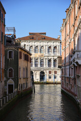 Vertical view of Venetian architecture and canal in Italy 