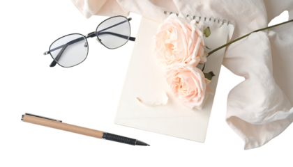 Elegant composition featuring roses, glasses, pen, and notebook on transparent background