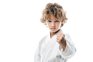 Young boy martial artist in white uniform showing punch isolated on transparent png background
