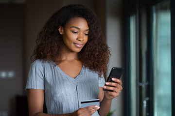 Digital Payment: A woman engages in a secure online payment transaction, holding a smartphone and credit card, signifying the ease of modern commerce.