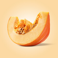 Slice of ripe pumpkin on dark beige background
