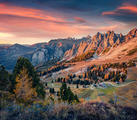 Astonishing evening view of Gardena Pass. Majestic auatumn sunset in Dolomite Alps. Spectacular outdoor scene of Italy, Europe. Traveling concept background.