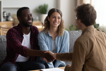 Handshake Agreement: A couple seal an agreement with a handshake, symbolizing collaboration, and teamwork. The image captures the essence of partnership and trust.