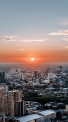 Fototapeta premium Beautiful sunset over a bustling city skyline with vibrant orange hues and skyscrapers in the foreground, capturing the day's end