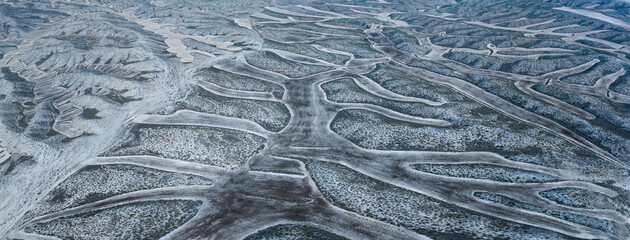 Aerial drone view of crop fields and eroded landscape in the Campo de Belchite region of Zaragoza...