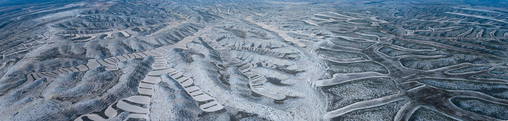 Aerial drone view of crop fields and eroded landscape in the Campo de Belchite region of Zaragoza...
