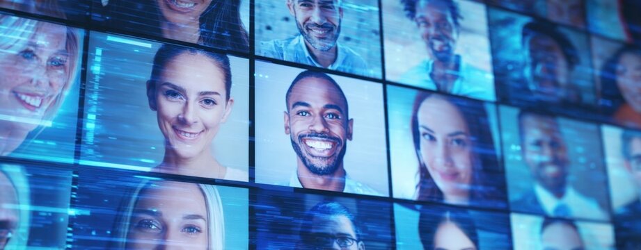 The video wall of diverse smiling professionals in a virtual meeting grid