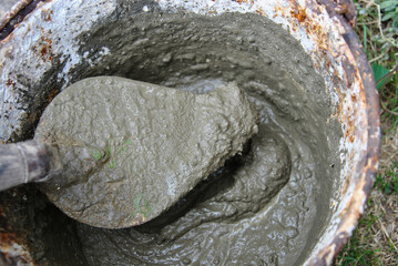 mason's trowel with cement mortar close-up