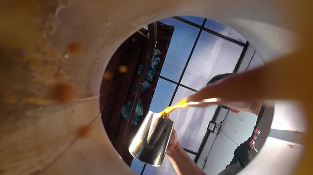 POV slow motion inside a jug while an Asian man making Teh Tarik inside a jug