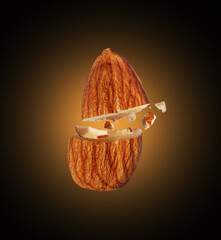 Crushed almond in the air close-up in the dark