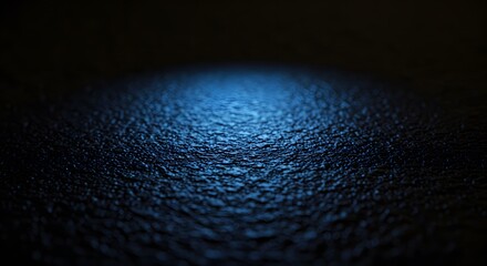Abstract macro photograph of a textured surface with blue light reflecting off the ripples and crevices.