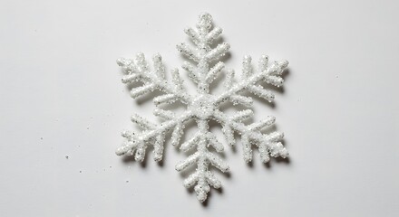 Close-up of a decorative, sparkly white snowflake, a symbol of winter and the holiday season.