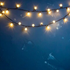 String lights in soft yellow-gold light on a textured navy blue background