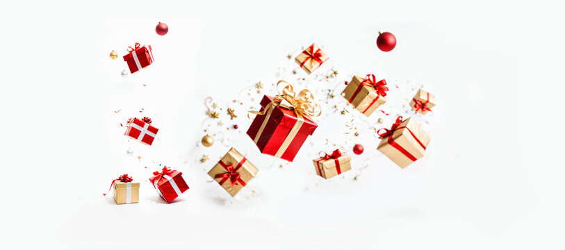 flying red and gold gift boxes with ribbons and ornaments for a festive christmas or birthday celebration on a clean white background.