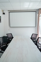 A Modern Conference Room Featuring a Spacious Table, Ergonomic Chairs, and a Large Projection Screen Ready for Presentations and Collaborations