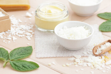 Emulsifier in a bowl  with diy cream, cosmetic ingredients and mix of wax , macro, closeup
