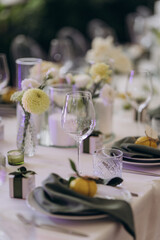 Elegant Table Setting Featuring Chic Glassware, Beautiful Flowers and Decorative Elements for a Memorable Dining Experience in a Softly Lit Atmosphere