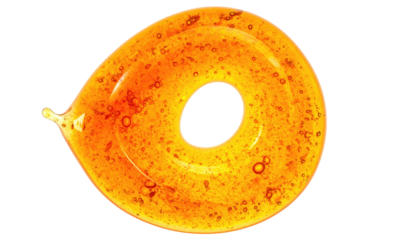 A swirling, translucent, amber-colored liquid forms a spiral shape with a dark, central hole