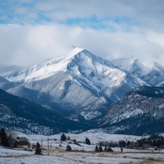 Mountain landscape of snow-capped mountains in the mist.

