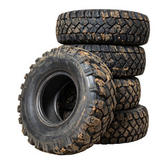A stack of five off-road tires covered in dirt, isolated on a black background