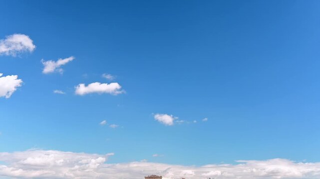 Downwards camera movement from a blue sky with clouds to the Acropolis of Athens. Establishing shot, travel concept.