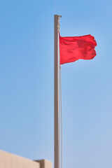 Red flag on the wind. Selective focus