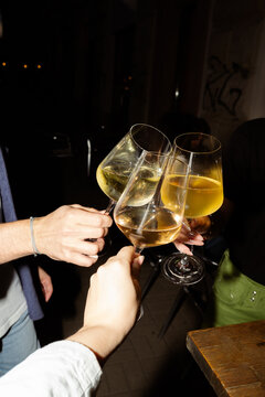 Hands with glasses of white wine