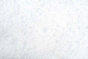 Background with uneven white snow. Winter texture with lumps of snow.