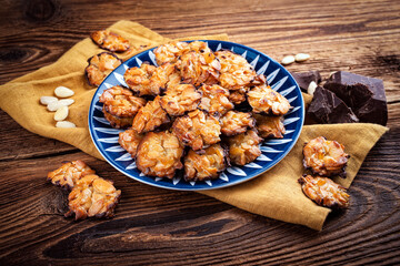 Homemade Florentine biscuits made of almond with dark chocolate served as close-up on  a design plate
