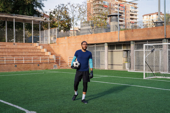 Confident goalkeeper at soccer pitch