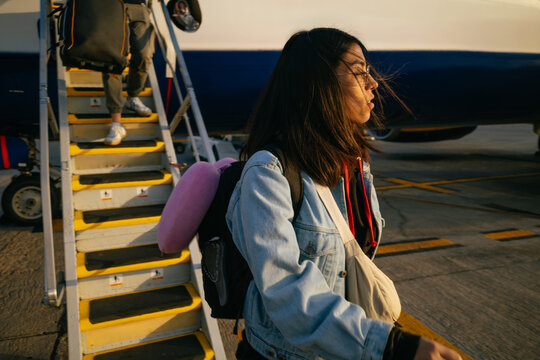 Traveler Descending Airplane Stairs