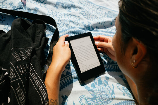 Reading Ebook on Beach Towel