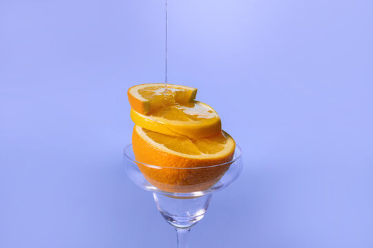 orange slices stacked in a stemmed glass
