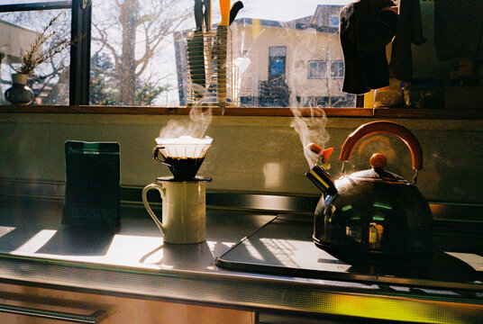 Brewing pour over coffee on sunny morning 