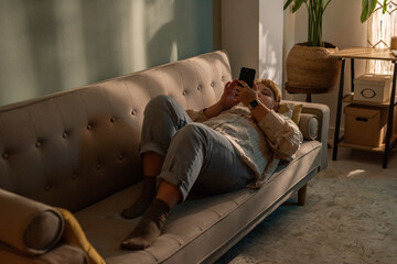 Relaxing at Home While Checking Smartphone Notifications