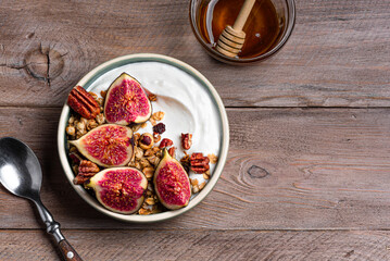 Granola breakfast bowl with figs and pecan nuts