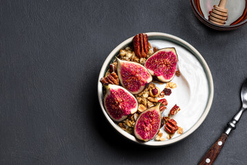 Granola breakfast bowl with figs, honey and pecan nuts