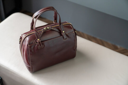 Brown Leather Handbag on Beige Sofa