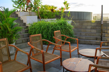 Patio with a wooden bench and several chairs