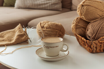 Knitting Project with Cup of Cappuccino on White Table in Cozy Setting
