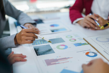Business team collaborating, reviewing marketing reports, and discussing financial insights during an office meeting