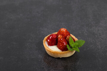 Mini Round Strawberry tartlet. Dark background. Close up