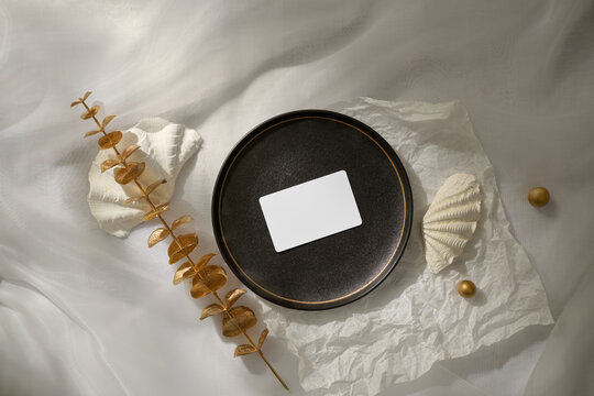 A sophisticated flat lay features a blank business card