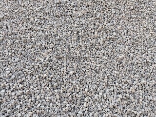 Close-up image of small grey gravel stones showing natural texture and irregular shapes. Ideal for use in construction, landscaping, and background textures in design projects.
