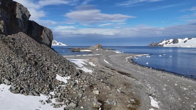 Breathtaking winter Arctic aerial sunset landscape. Frozen beauty Antarctica nature. Colorful clouds sky reflected in Polar frozen ocean water. Snow covered mountain, glacier, iceberg. Travel, explore