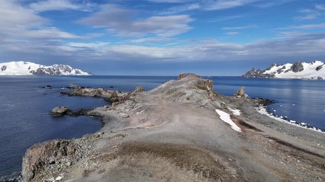 A beautiful cape jutting out into the sea. The beautiful coastline of Antarctica. View from above.