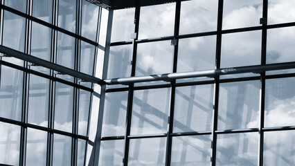 Large window with blue sky and clouds. sky is clear and bright, and the clouds are scattered throughout  sky. window is made of glass and is located in a building